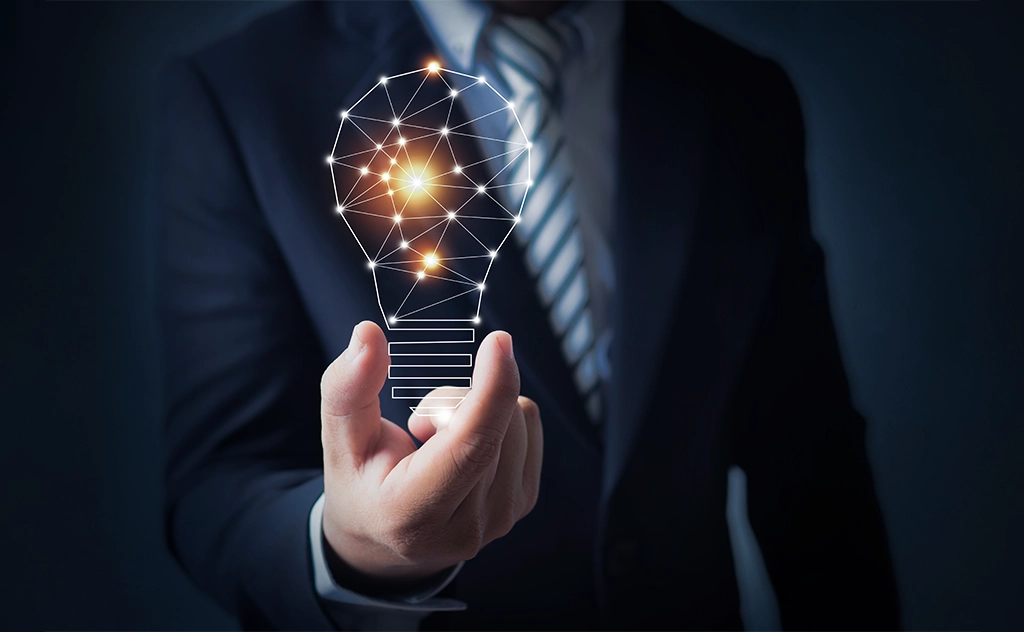 AIBN team member holding a lightbulb, symbolizing a great business idea.