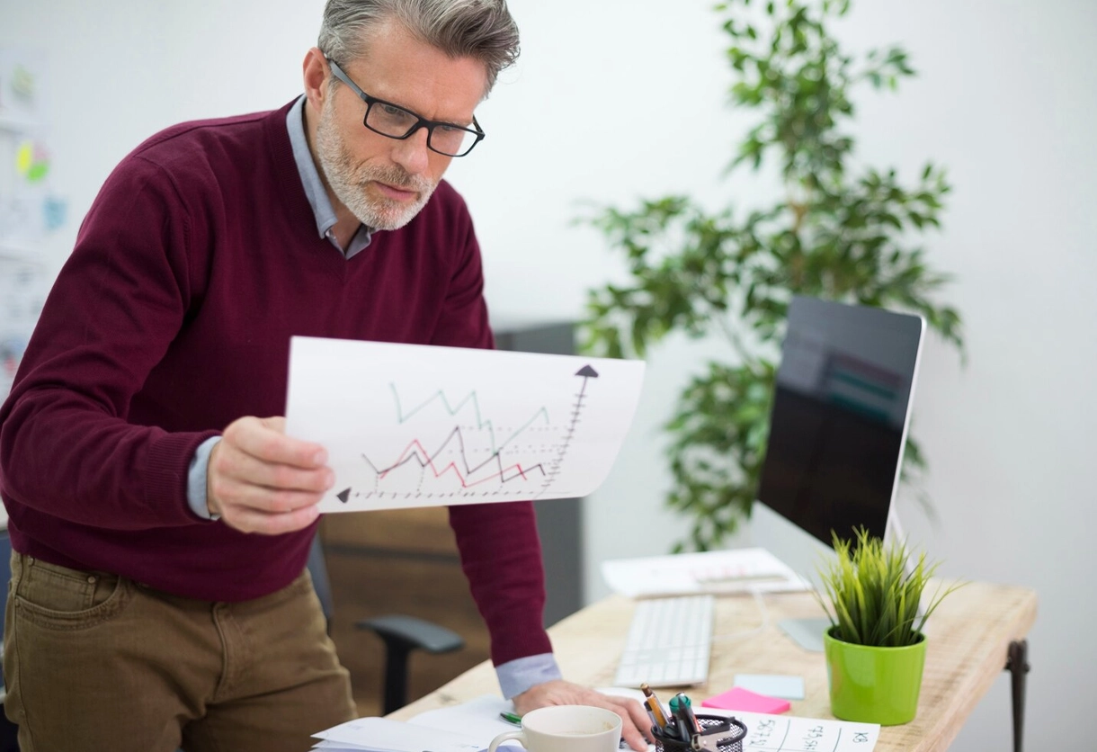 AIBN analyst reviewing line graph for pricing trends and strategic market positioning.