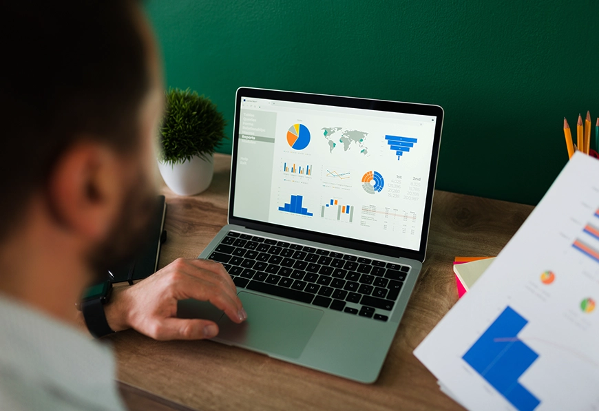 AIBN laptop showing charts and graphs, symbolizing data-driven analysis and global strategy.