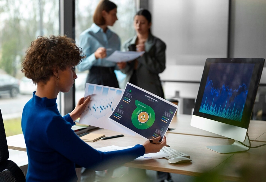 AIBN professional presenting charts and graphs in modern office, symbolizing market research and strategic planning.