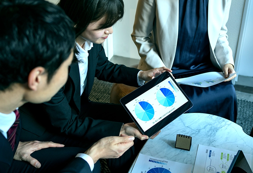 Team analyzing charts showing AIBN business expansion planning.