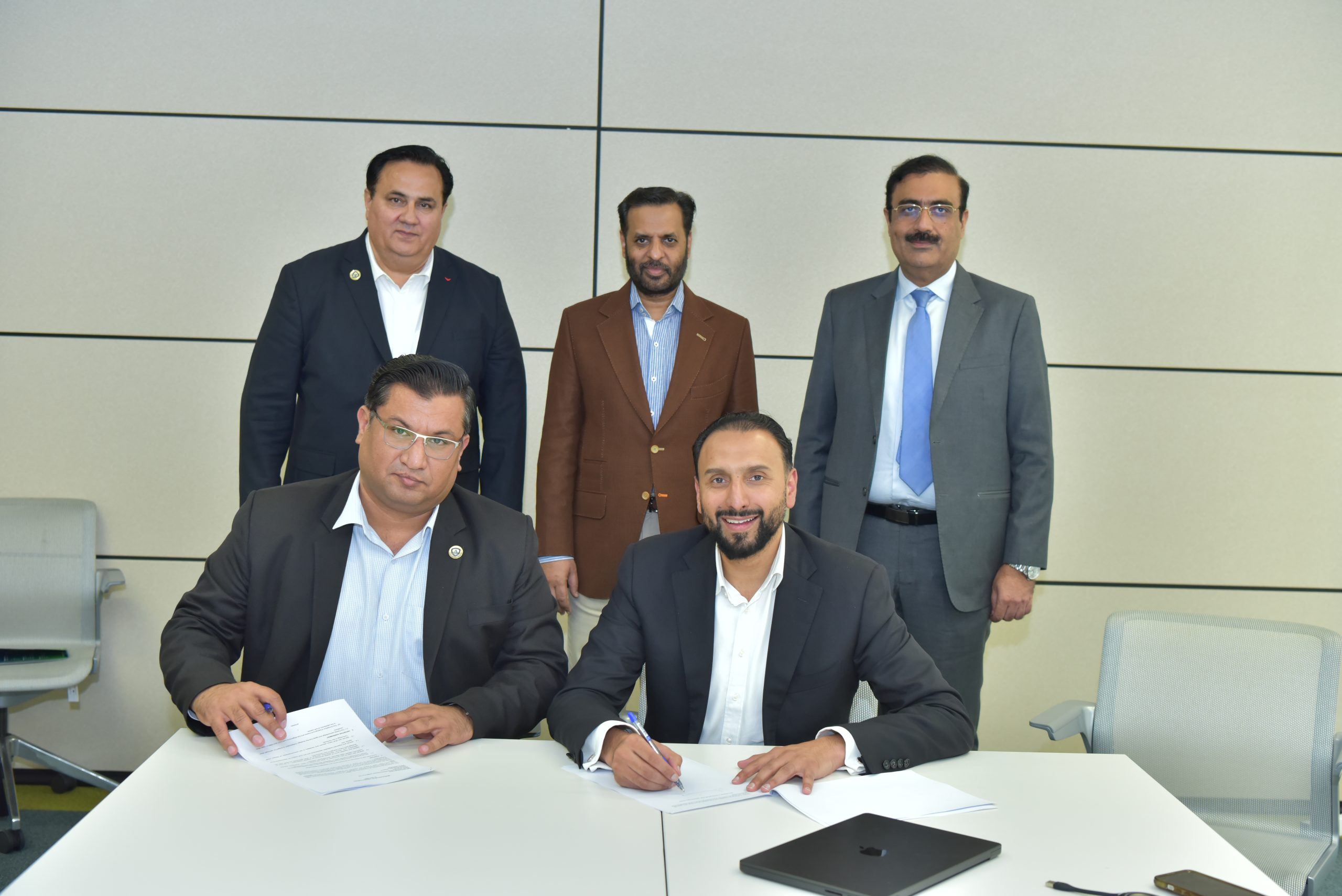 AIBN business professionals signing a partnership agreement.