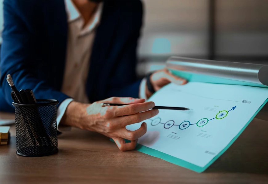 Person pointing at process chart on clipboard.