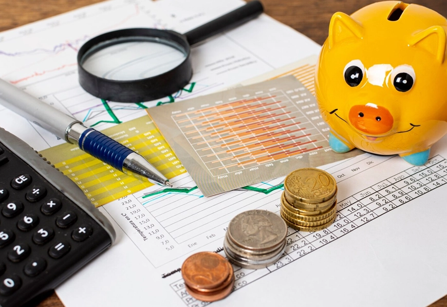 AIBN piggy bank and charts symbolizing financial analysis and trade policy advisory.