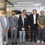 A group of business professionals from AIBN and partners at a business meeting.