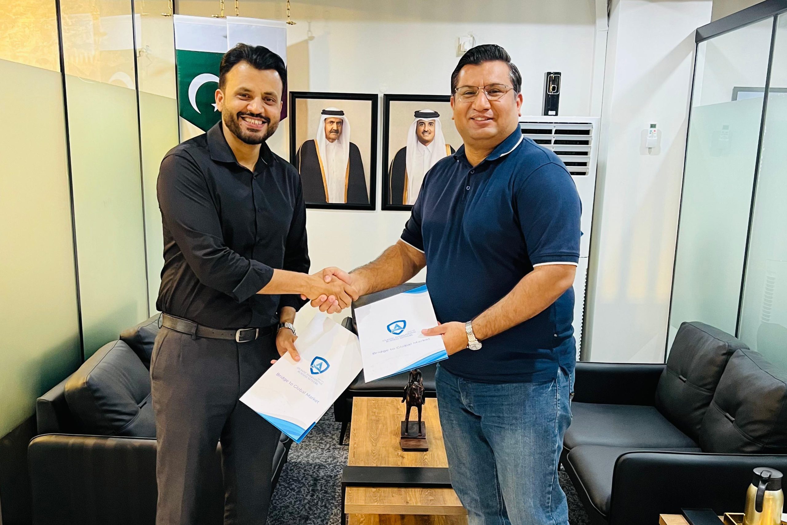 Two AIBN team members shaking hands after a successful business deal.