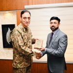 A representative from the Pakistan Armed Forces is presenting an award to an AIBN official, symbolizing their strategic business partnership.